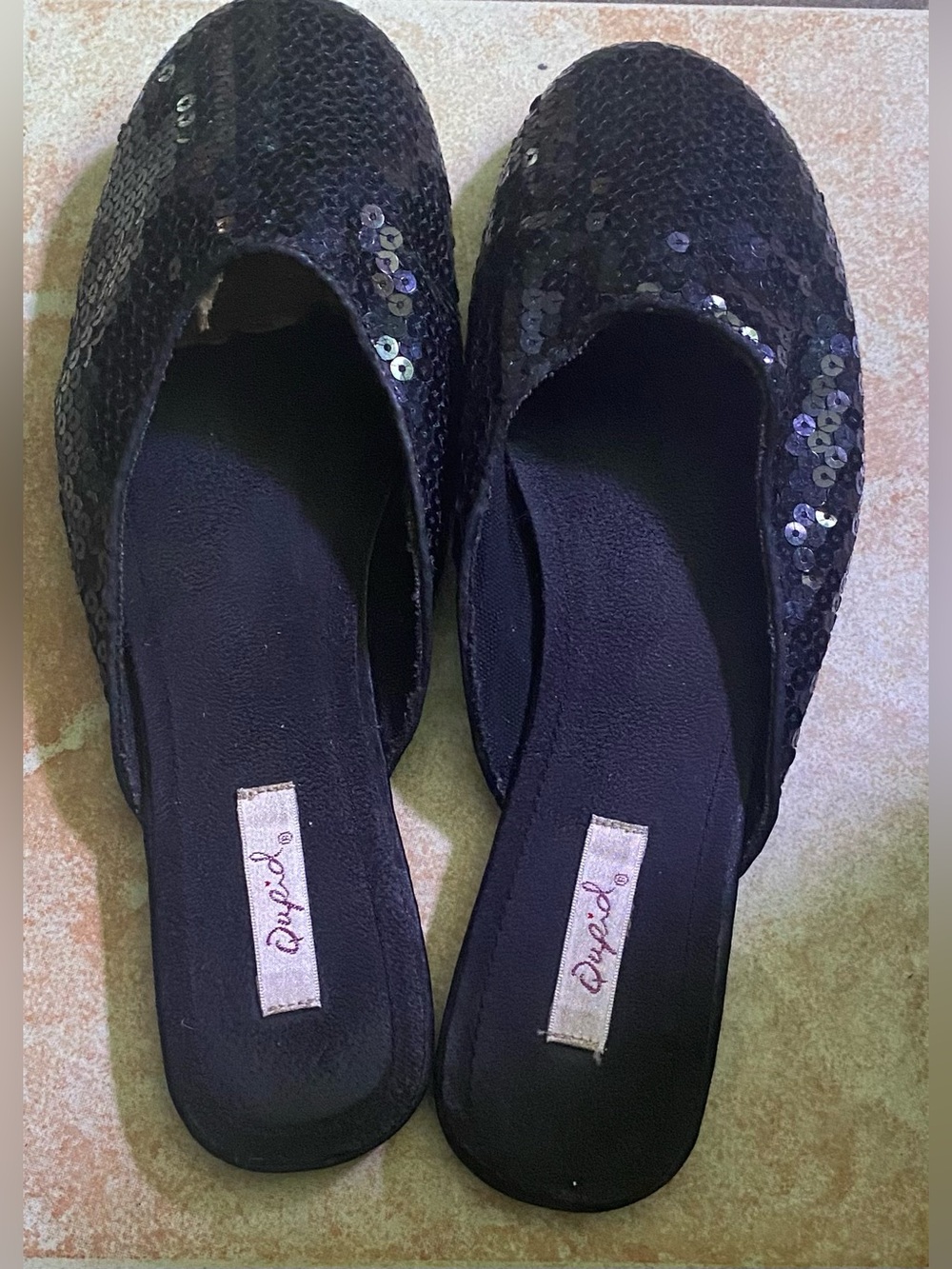 Women’s black sequin slip-on mule flats.